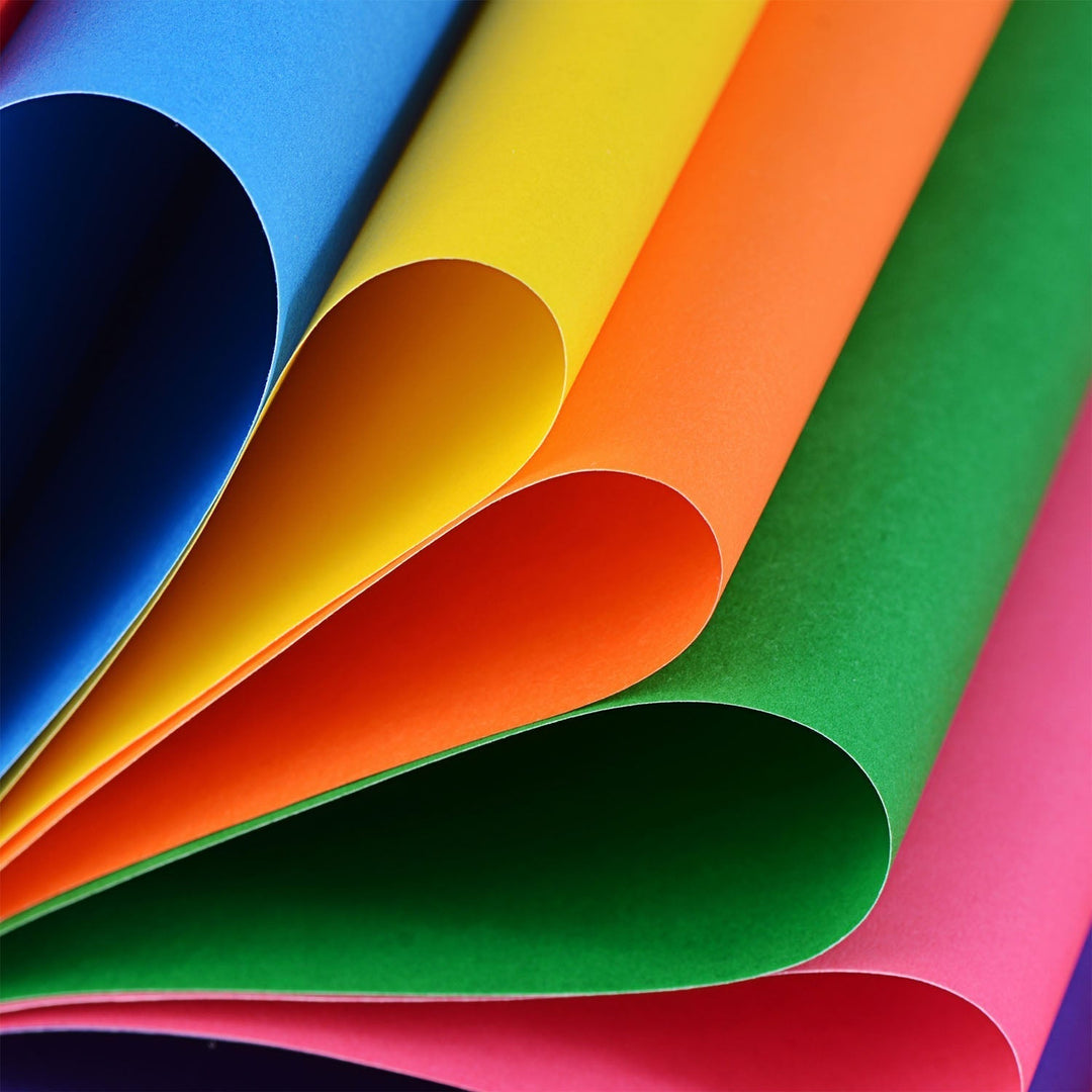 A close-up arrangement of overlapping colored paper 
