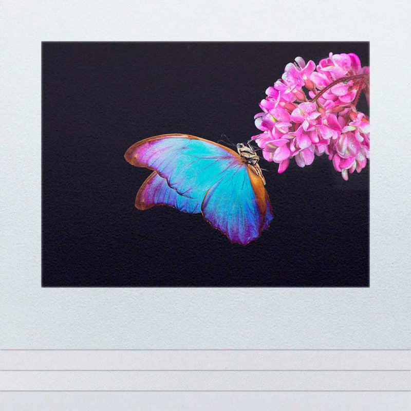 Vibrant butterfly and pink flowers on a stack of paper.