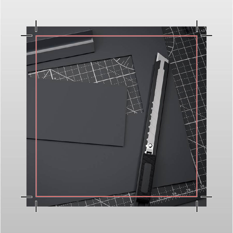 Black paper with a ruler and knife on a gray background