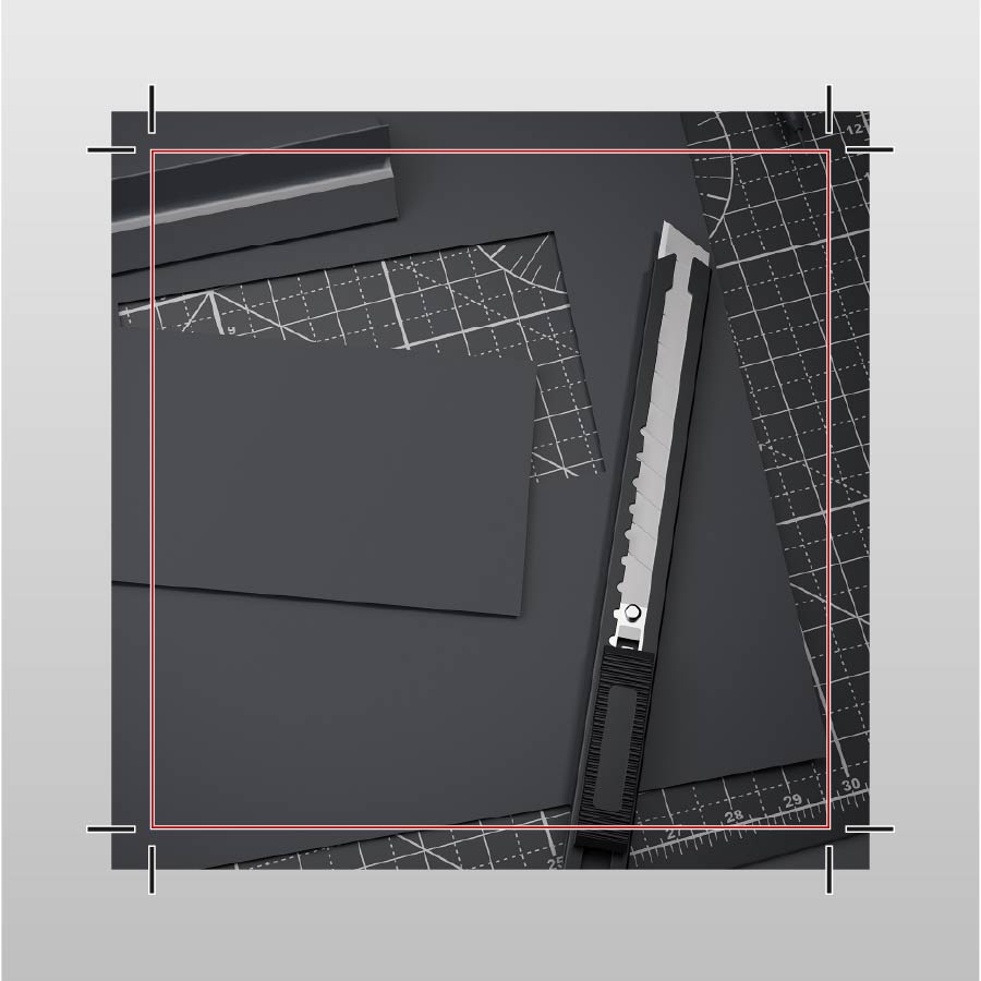 Black paper with a ruler and knife on a gray background
