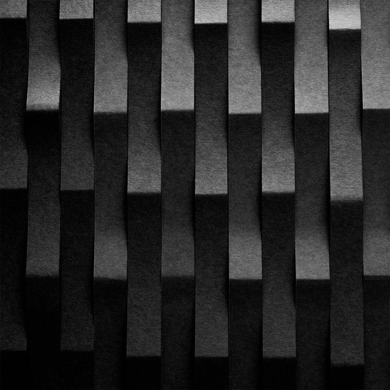 Abstract black and gray 3D geometric wall paneling with vertical wavy ribbed bars.