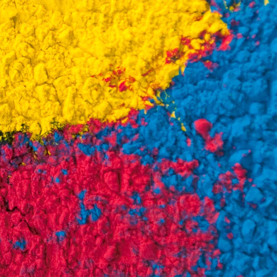 Close-up of colorful powder in yellow, blue, and red.