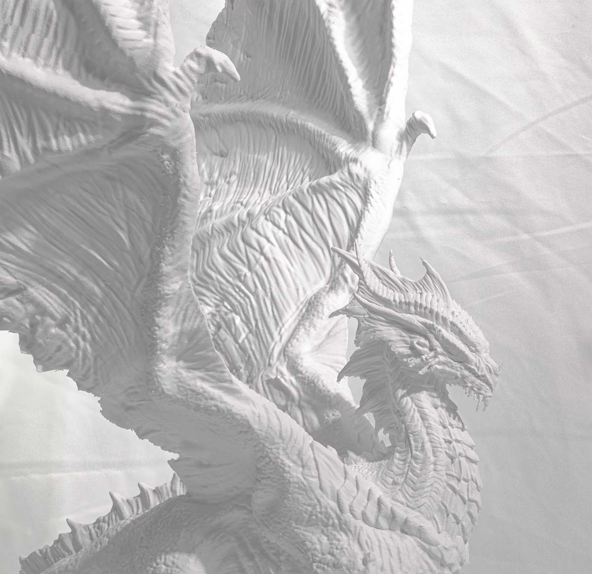 Close-up of a 3D printed dragon sculpture. 3D Merchandise cover photo by Uproar Design & Print.