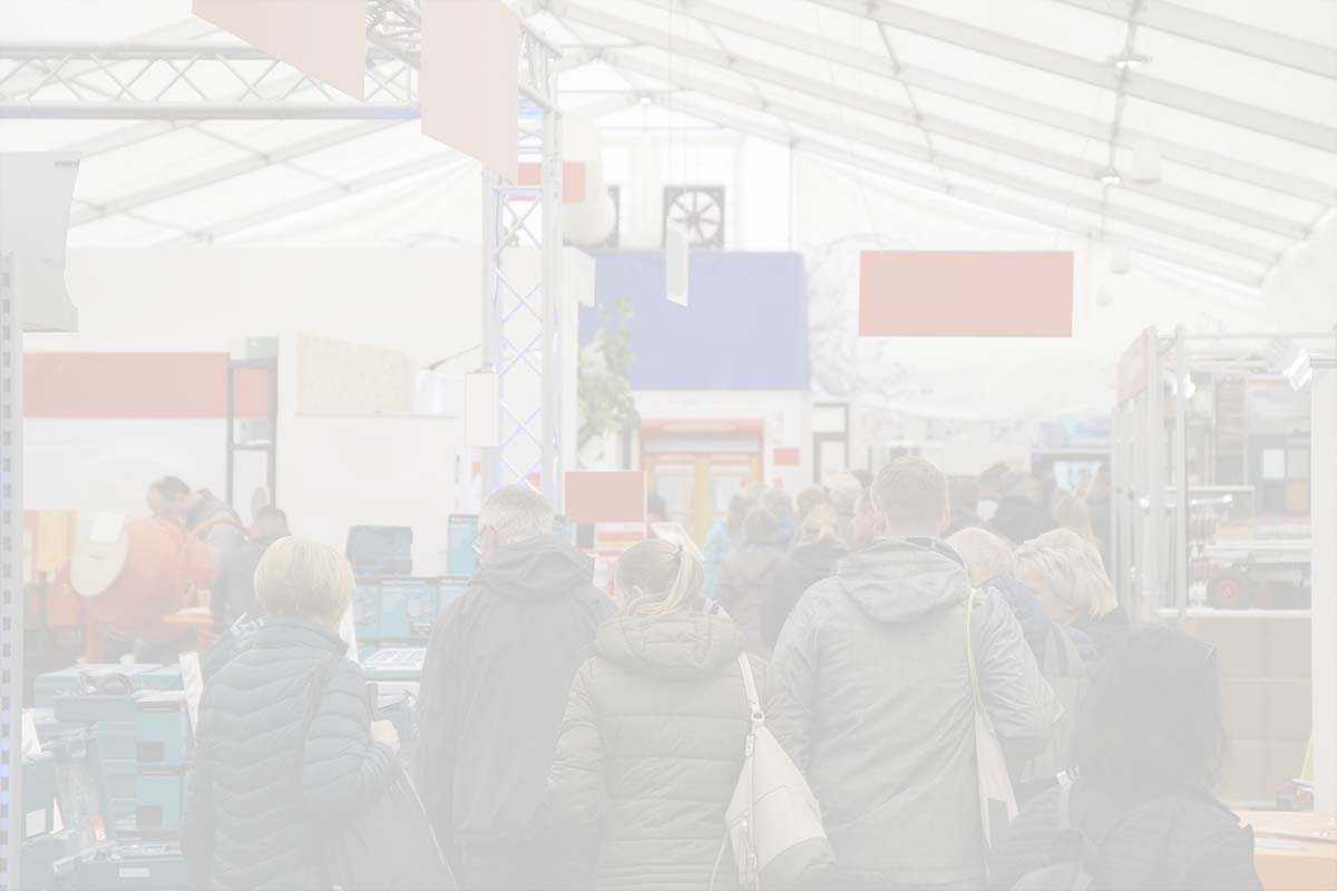 Indistinct indoor scene with people and colorful flags