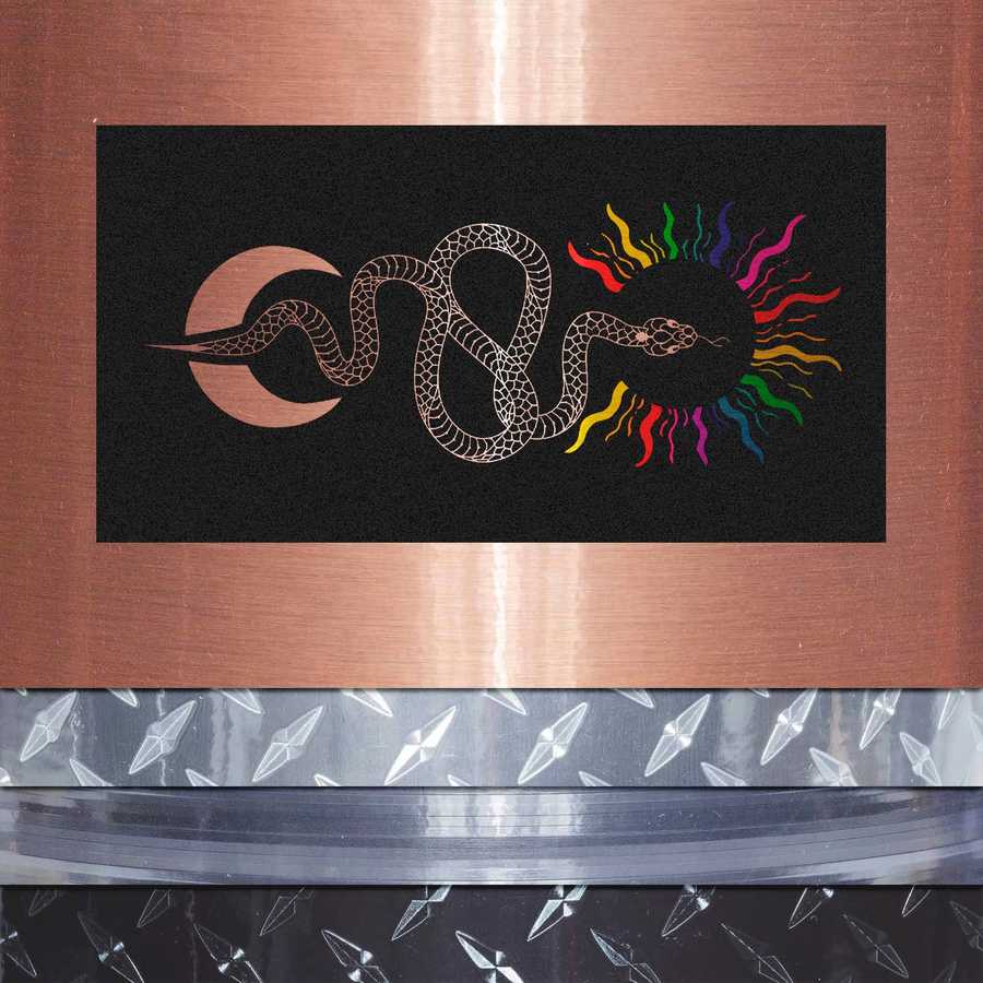 Decorative mat with a snake design on a metallic surface
