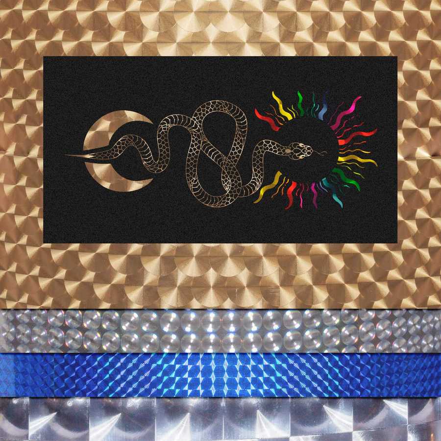 Decorative mat with snake design, rainbow colors, and geometric patterns on a textured surface.